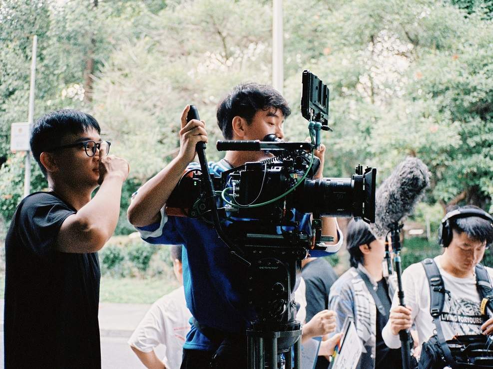 Yifu operating camera on set, with Dolly Grip Lucian Jin, Photo credit- Evan Feng